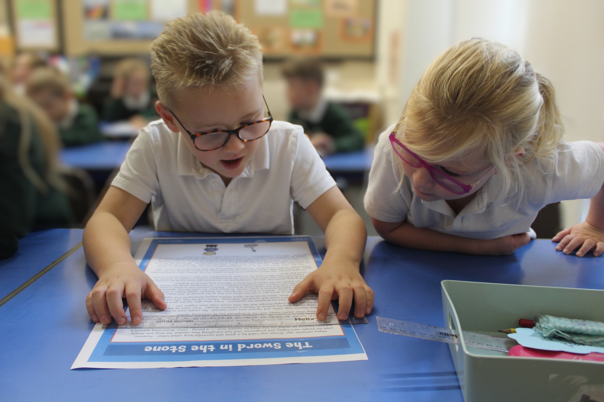 Two students looking at a reading text together